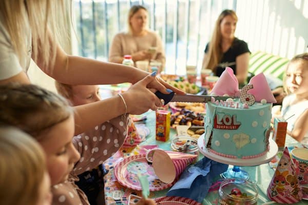 Guests around the table as the cake is cut